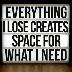 Motivational lightbox with quote: 'Everything I Lose Creates Space for What I Need'.