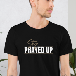 Person wearing black Stay Prayed Up Tee with bold Christian statement design
