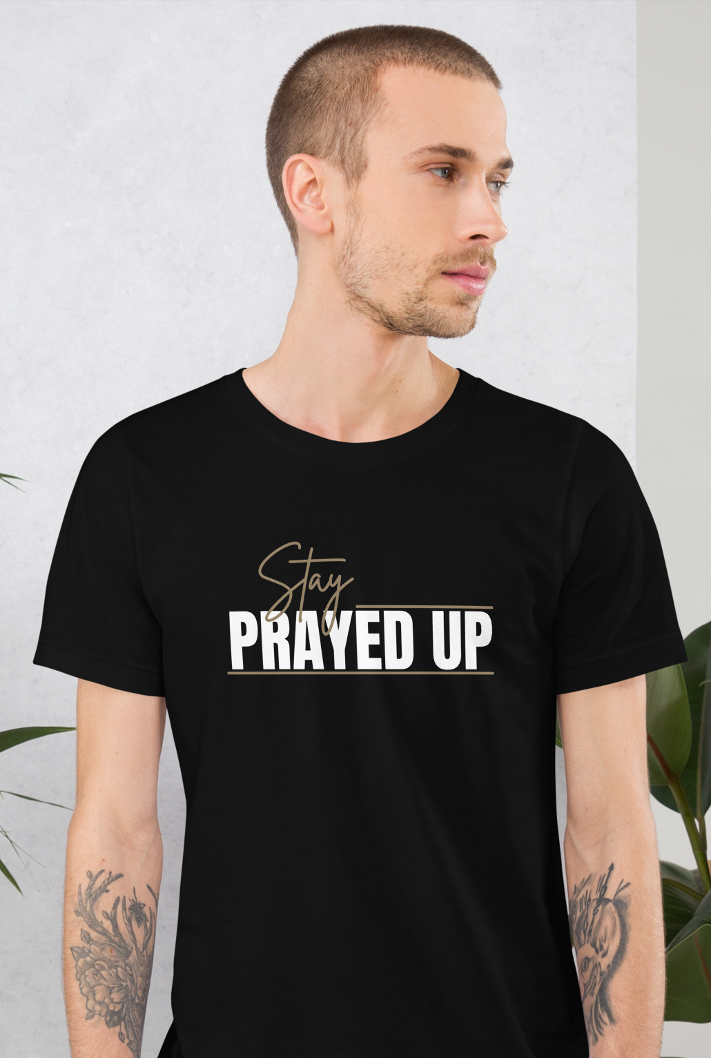 Person wearing black Stay Prayed Up Tee with bold Christian statement design