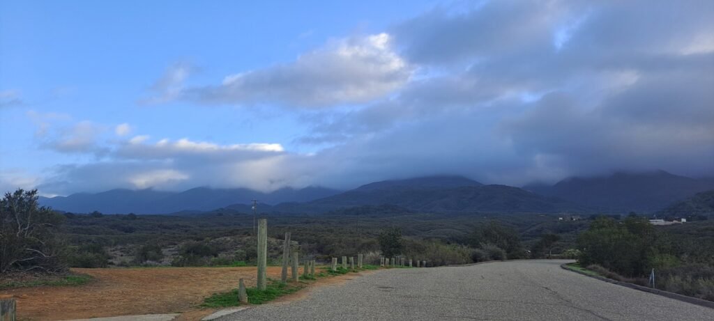 Low clouds covering mountains near Santa Ynez, California beside a winding road