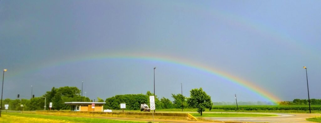 Double rainbows stretching across a stormy sky near Loudon Township, Illinois