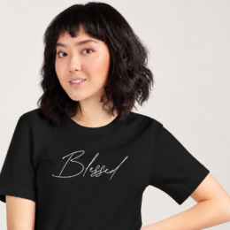 Woman wearing black Blessed Tee with minimalist faith-based script design