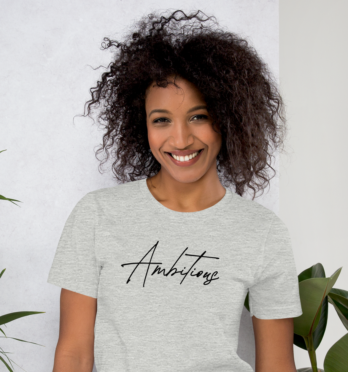 Model wearing Athletic Heather Ambitious Tee with minimalist statement script design