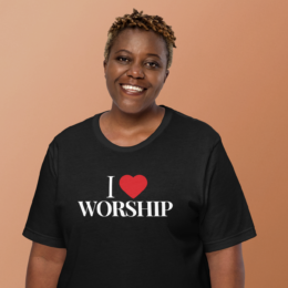 Model wearing black I Love Worship Tee with red heart design