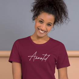 Woman wearing maroon Anointed Tee with minimalist faith-based script design