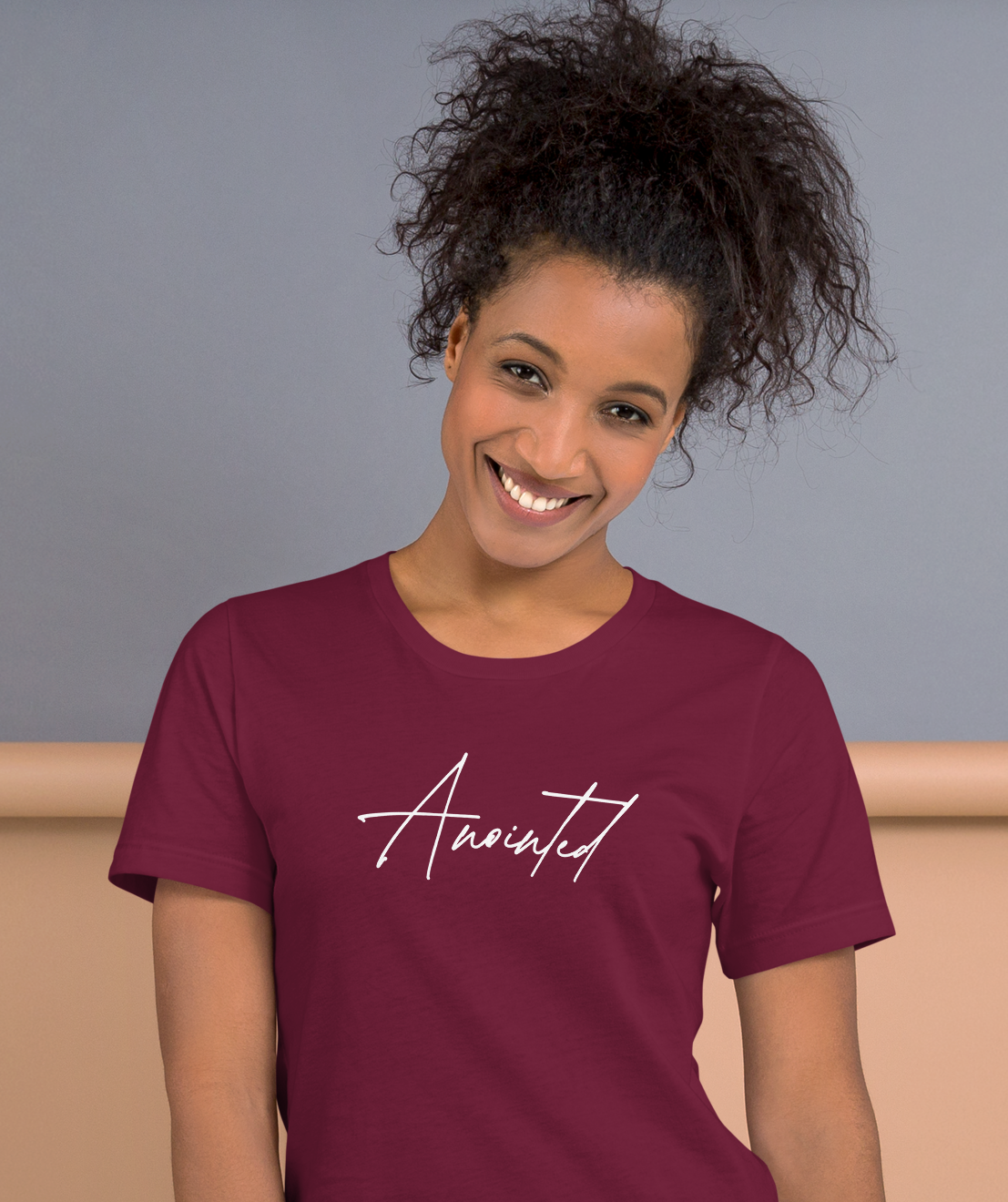 Woman wearing maroon Anointed Tee with minimalist faith-based script design