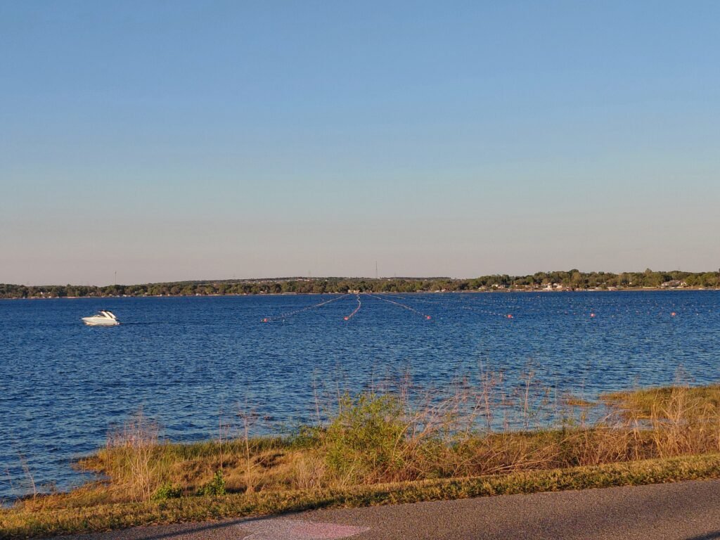 Scenic lake view with a boat on the water during a peaceful afternoon walk