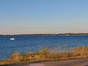 Scenic lake view with a boat on the water during a peaceful afternoon walk